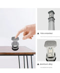 Heavy Duty Pop Up Power Strip With Integrated Wireless Charging Pad on desk with hand activating retractable mechanism.