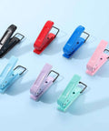 Colorful handheld paper punches on a blue background, featuring various shades including black, suitable for tags, crafts, and scrapbooks.