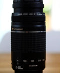Go-To 75-300mm Telephoto Zoom Lens With F4 To F5.6 Aperture For SLR Cameras, black compact design, front view close-up.