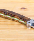 Close-up of a wooden knife handle with visible G10 spacer from the 20 Pcs G10 Spacer Sheets For DIY Knife Making Kit in 10 colors.