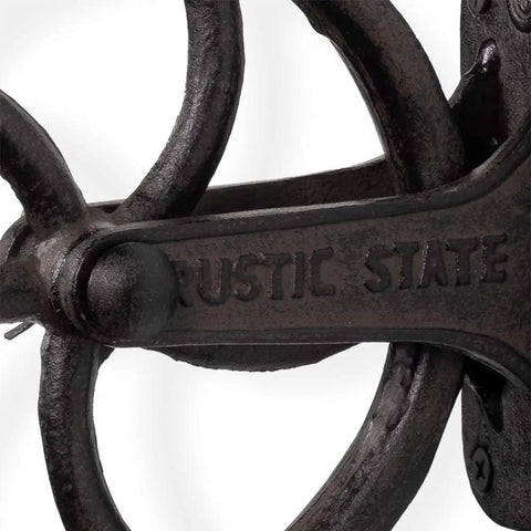 Close-up of Heavy Duty Cast Iron Vintage Industrial Wheel Pulley Wall Mount, black finish with 'Rustic State' text