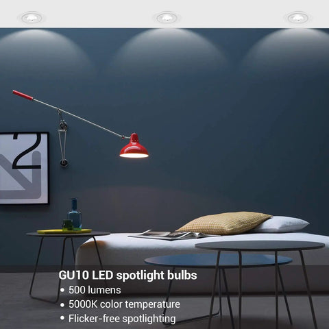 Modern living room with GU10 LED spotlight bulbs, highlighting an armchair and table, 5000K daylight illumination, 500 lumens.