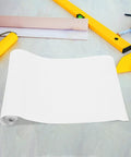 Killer Slick Clear Self Adhesive Wall Paper Roll For Kitchen Backsplash Protector and Fridge Wrap laid on a surface with tools.
