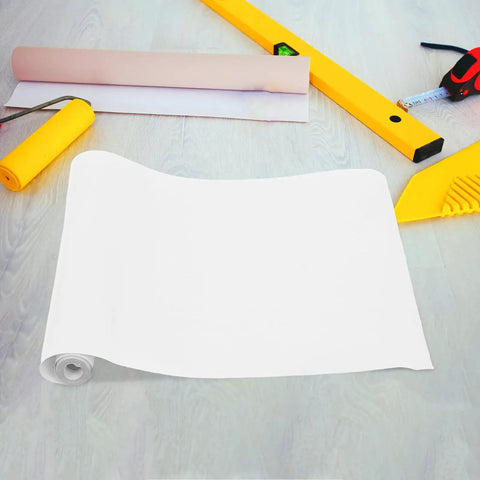 Killer Slick Clear Self Adhesive Wall Paper Roll For Kitchen Backsplash Protector and Fridge Wrap laid on a surface with tools.