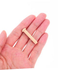 Miniature Wooden Nails Set For Dope Crafting And Woodworking With Solid Wood Rods For Tiny Train Wheels And Detailed Projects 20 Pieces Easy To Handle T Shaped Heads Durable Small Wood Nails For Crafts shown in hand