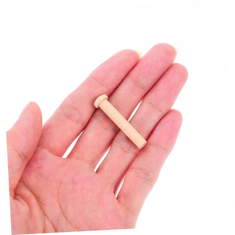 Miniature Wooden Nails Set For Dope Crafting And Woodworking With Solid Wood Rods For Tiny Train Wheels And Detailed Projects 20 Pieces Easy To Handle T Shaped Heads Durable Small Wood Nails For Crafts shown in hand