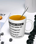 11oz Funny Tech Support Checklist Coffee Mug for Help Desk Heroes filled with tea and spoon, surrounded by books and snacks.