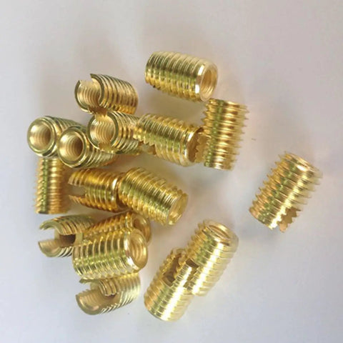 Heavy Duty 50 Pack M3 Slotted Thread Repair Kit With Carbon Steel Self Tapping Inserts For Fast And Durable Screw Fixes That Hold Firm Under Vibration. gold M3 carbon steel self tapping thread repair inserts on white background