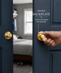 Slick Brushed Gold Cabinet Knobs Two Pack Modern Three Groove Handle Style shown on dark door with hand gripping knob.