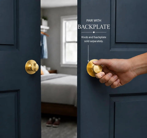 Slick Brushed Gold Cabinet Knobs Two Pack Modern Three Groove Handle Style shown on dark door with hand gripping knob.