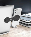 Ultra Thin Aluminum Laptop Phone Holder With Magnetic Quick Mount attached to silver laptop on desk