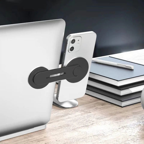 Ultra Thin Aluminum Laptop Phone Holder With Magnetic Quick Mount attached to silver laptop on desk