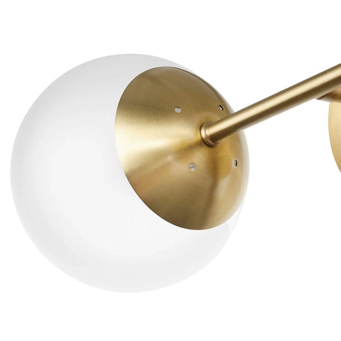 Close-up of Celestia 2-Light Wall Sconce in matte brass with frosted glass shade for a modern glam vibe and cozy glow