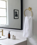 Elegant bathroom scene with towel on ring, part of All In One Antique Brass Bathroom Accessories Set With 24 Inch Towel Holder And Wall Mount Hardware.