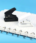 Two Pack Small Black And White One Quarter Inch Circle Hole Punch Handheld Tool for Paper and Leather Craft on notebook