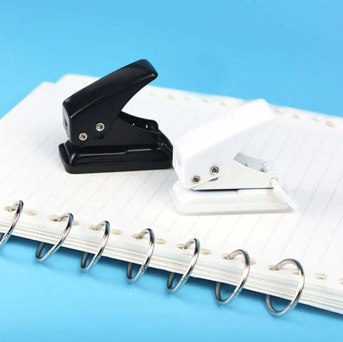 Two Pack Small Black And White One Quarter Inch Circle Hole Punch Handheld Tool for Paper and Leather Craft on notebook