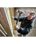 Man using Heavy Duty 22 Oz Framing Hammer With 1-Piece Steel Construction, Yellow and Black Finish, Model DWHT51064 for nailing