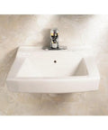 Declyn 4-Inch Centerset Wall Mount Sink White for a Slick Bathroom Upgrade, 17-Inch Length, 1-1/4-Inch Faucet Hole, Durable Ceramic Construction, Easy Install, Model 0321026.020 shown mounted on a beige wall
