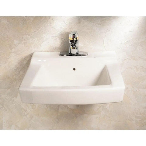 Declyn 4-Inch Centerset Wall Mount Sink White for a Slick Bathroom Upgrade, 17-Inch Length, 1-1/4-Inch Faucet Hole, Durable Ceramic Construction, Easy Install, Model 0321026.020 shown mounted on a beige wall