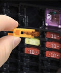 Close-up of hand using puller from Garage Must Have Car Fuse Kit 1200Pcs Assortment With 520 Standard Fuses 680 Premium Fuses Plus 1 Puller Zinc Case