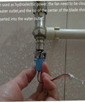 Hand installing Portable Mini Wind And Hydro Generator Dual Powered Educational Kit under water outlet