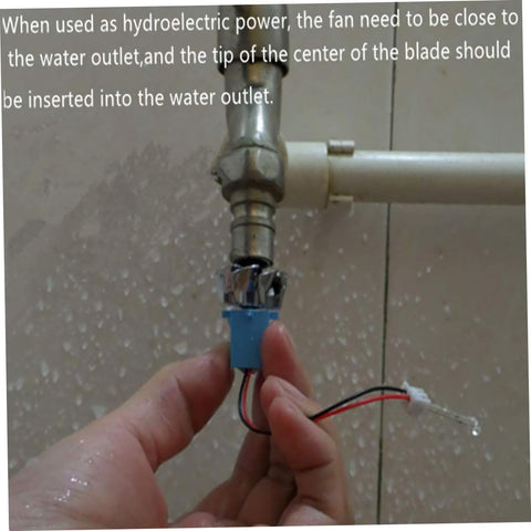 Hand installing Portable Mini Wind And Hydro Generator Dual Powered Educational Kit under water outlet