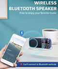 Bluetooth AM FM Portable Radio With Dual Speakers And Heavy Bass LED Flashlight on table with smartphone and cup
