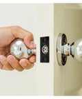 Hand grasping a shiny doorknob near a sleek stainless steel ball catch for door tops 12 set super adjustable spring hidden latch mechanism.