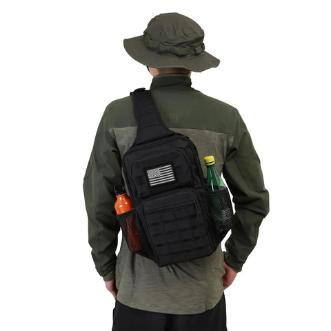 Man wearing Rugged Tactical Sling Pack For Everyday Carry, Shoulder Crossbody Bag With Bottle Holder, 13L Capacity, in black with grey patch.