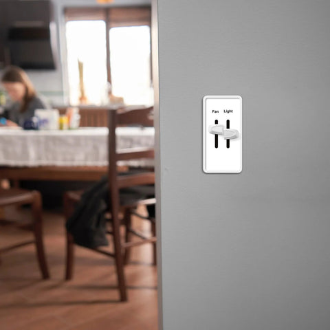 Two white replacement dimmer knobs on a wall plate for Lutron Skylark fan and light control