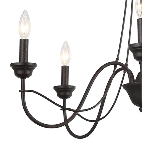 Close-up of brown rust metal finish arm on 5 light farmhouse chandelier with Edison candelabra bulbs for dining room.