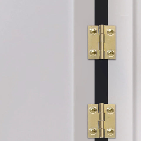 FOYTOKI foldable brass cabinet door hinges, pair installed on a white cabinet edge, gold finish with screws