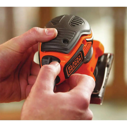 Hands holding Powerful Two Point Zero Amp Orbit Sander for finish work on wood, metal, and plastic with paddle switch visible.