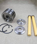 Front view of waterjet piston assembly parts: grooved metal piston, two yellow rods, round end plates, circlips, washers.