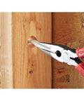 8-Inch Long Nose Pliers With Reaming Head And Onboard Fish Tape Pulling in use on wooden panel with red handle