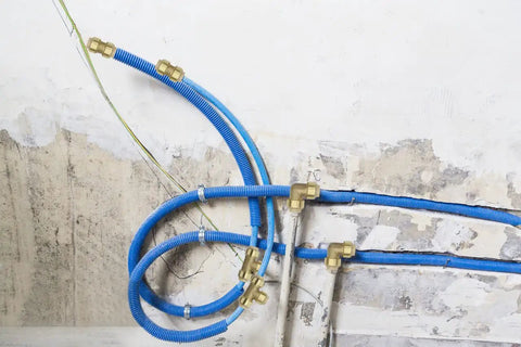 Installed Six Pack 1/2 Inch Push Fit Tee Fittings With Disconnect Clip For Copper PEX CPVC Pipes in blue tubing system