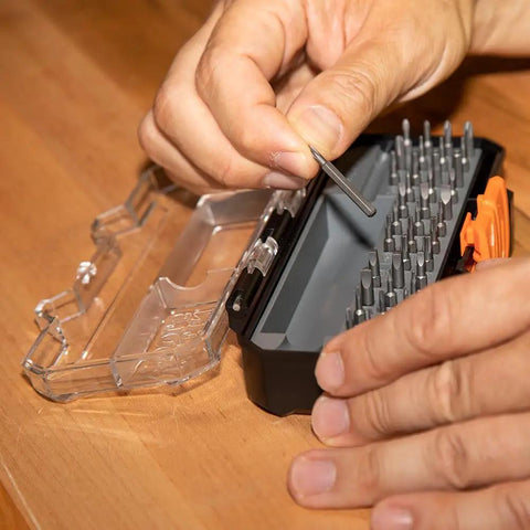 Pro Grade Precision Driver Kit With 39 Bit Multi Screwdriver And All In One Repair Tool For Apple Devices 2 Piece Set Magnetic Bits For Quick Pick Up Today showing hand picking a bit from open case.