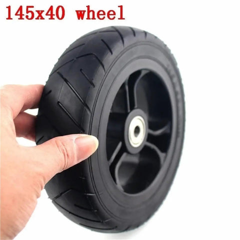 Hand holding 6 Inch Solid Tire Set For Electric Skateboard Longboard Airless Wheel 145x40 With Plastic Hub And Pulley Upgrade Durable