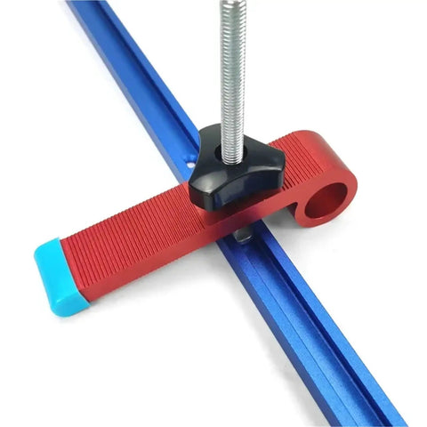 Close-up of Game Changing Aluminum T Track T Slot Fixture Channel with red clamp and blue rail for precise woodshop guides.