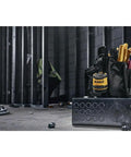 Rugged Jobsite Bluetooth Speaker With USB C Rechargeable Battery IP67 seen in a construction setting with tools and equipment.