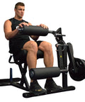 Man exercising on Plate Loaded Leg Extension And Curl Machine For Home Gym Seated Leg Curl And Quad Extension with 180 lb plate load
