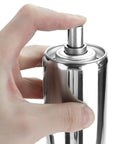Person pressing top of a stainless steel spray canister, close-up view