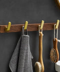 Straight Up Sturdy Five Hook Wall Coat Rack Designed For Hanging Daily Duds Hats Keys And Towels Helps You Keep Your Entryway And Bathroom Tidy With Easy Mounting Hardware Included, featuring five hooks with a wood base.