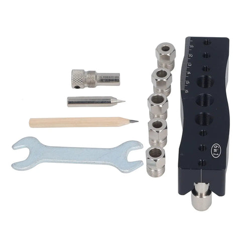 Knockout Centering Dowel Jig For Woodworkers With Rock Solid Aluminum Build, includes metal pieces, wrench, and pencil for precise drilling.