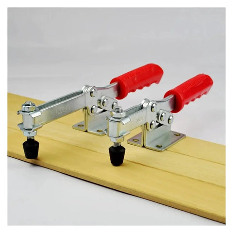 Heavy Duty Horizontal Toggle Clamp Metal Plunger Push Pull Fixture For Welding And Garage Builds with red handles on wood.