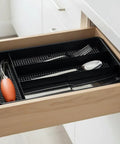 Swanky Four Compartment Utensil And Cutlery Drawer Organizer Tray In Matte Black For Kitchens Or Junk Drawers With Drainage Mesh Bottom keeps utensils organized in drawer.