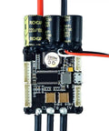 Close-up of Dope 50A Mini FSESC 4.20 Electric Skateboard Speed Controller showing capacitors and wiring, with aluminum heat sink.