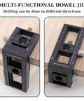 Upgraded 2-In-1 Drill Guide Positioning Clamp With Self Centering Clamp Graduated Aluminum Woodworking Tool Featuring 8 Drill Bushings 3-10mm Vertical Multi Angle Jig For Precise Straight Holes And Pro Grade Accuracy, shown clamped to wood piece for precise drilling.