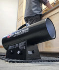 Portable 125000 BTU propane forced air heater for construction sites with 10 feet hose and regulator, side view.