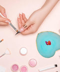 Two Pack Resin Nail Art Palette With Gold Edge Mixing Tray For Nail Polish on table with nail tools and pink glitters